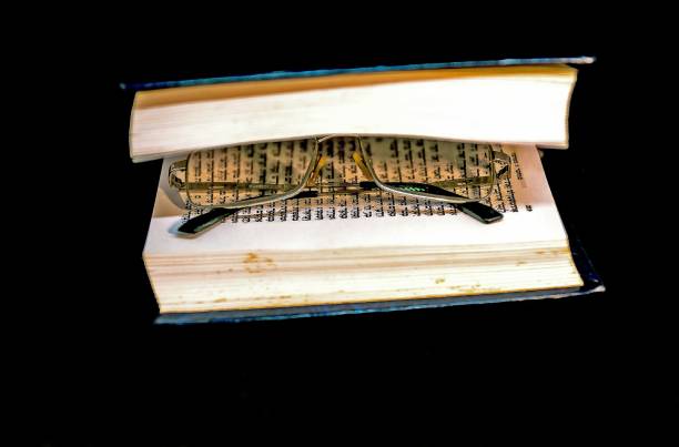 istock Talmud Torah Tanakh Book on black background with spectacles. Selective focus. 1226250240