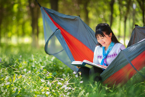 Asian women reading in hammocks