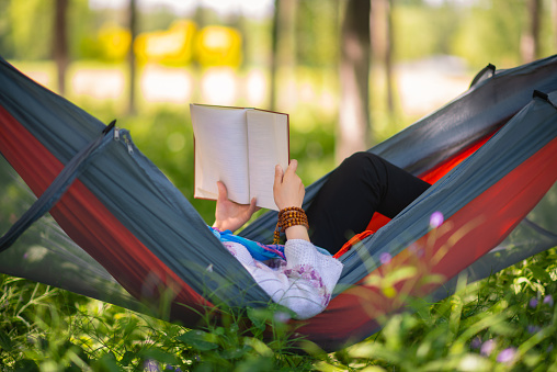 Asian women are very comfortable reading in hammocks