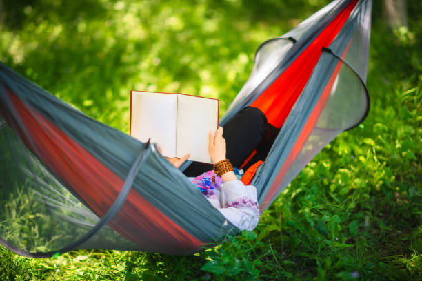 istock Asian women are very comfortable reading in hammocks 1226251586