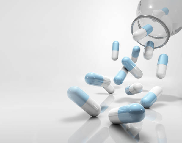 istock medicine capsules flying, falling out of glass container 1226251656