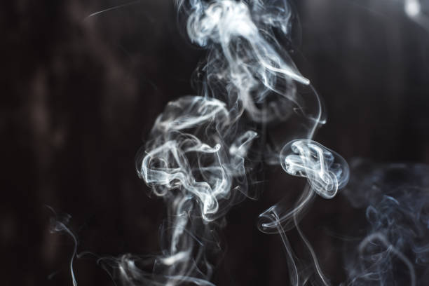 istock Image of backlit puffs of smoke, on a dark background. 1226252000