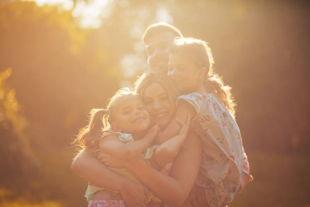 Family is bliss. Parents with daughters playing in nature.