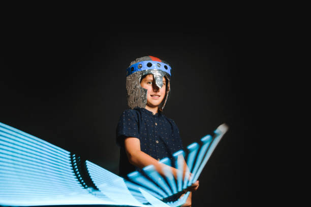 istock A kid with a light saber in his hands play in a superhero battle. 1226252942