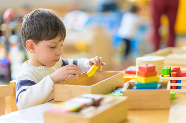 istock Cute Little Boy Playing at Kindergarten with Construction Toy 1226252966
