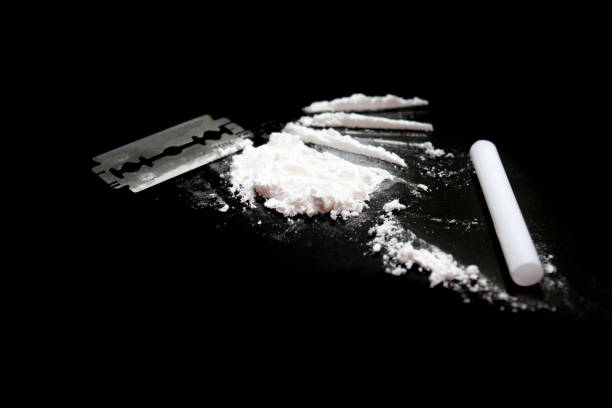 istock Cocaine and Razor blade on a black background 1226254402