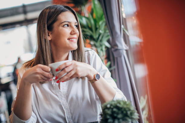 istock Young woman sitting alone in cafe 1226254522