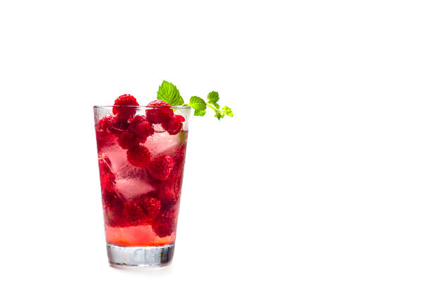 istock Raspberry alcoholic cocktail with liqueur, vodka, ice and mint on a white background. Raspberry Mojito. Refreshing cool drink, lemonade or ice tea in a glass. Close up, copy space for text 1226256233