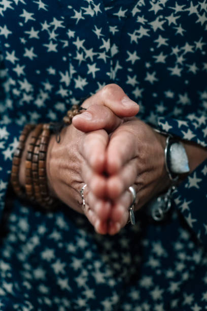 istock Woman Holds Hands Joined Together at Chest. 1226256243