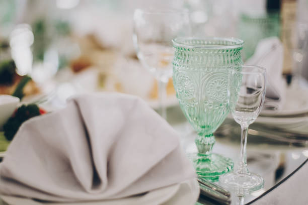 istock Wedding luxury table setting at reception in restaurant. Stylish glasses for wine, plate with napkin, cutlery and food on tables. Luxury catering service. Christmas feast 1226256811