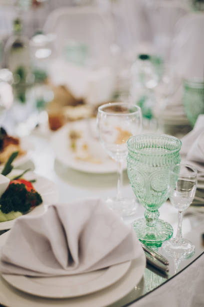 istock Wedding luxury table setting at reception in restaurant. Stylish glasses for wine, plate with napkin, cutlery and food on tables. Luxury catering service. Christmas feast 1226256850