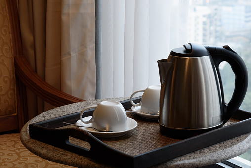 Electric kettle and coffee cup set in hotel room, ceramic cup set,