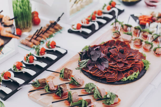 istock Delicious appetizer and canape on table at wedding reception in restaurant. Luxury catering service. Italian delicatessen, prosciutto snacks, cheese and olives. Christmas feast 1226256917