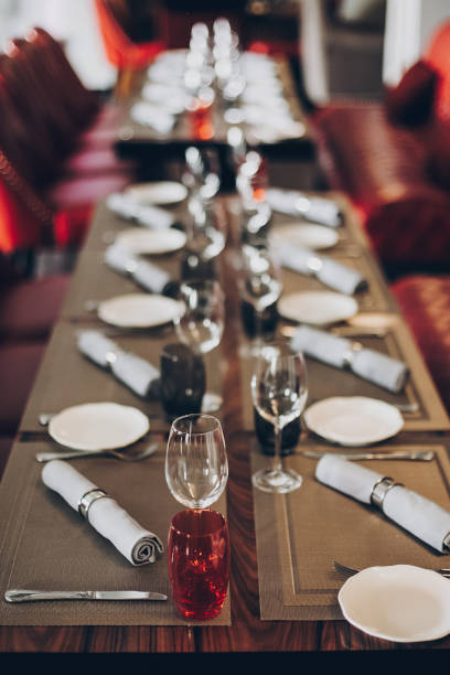 istock Luxury red table setting at reception in restaurant for wine party or wedding. Stylish glasses for wine, plates with napkin, cutlery on table. Modern red catering service. Christmas feast 1226256981