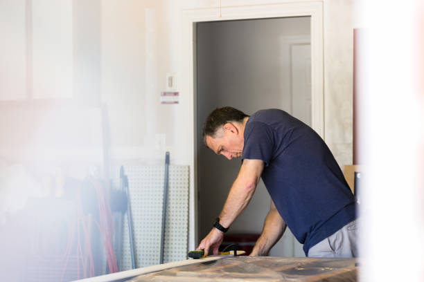 istock Man concentrates as he clamps the wood strip before cutting 1226257002