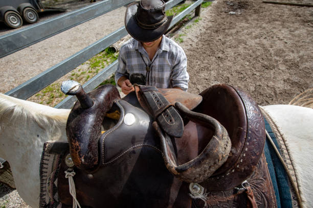 istock High Angle View on Cowboy Adjusting Saddle on His Horse 1226259667