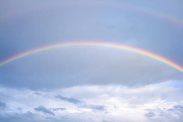 istock Rainbow formed after rain with clouds and blue sky in the background 1226260069