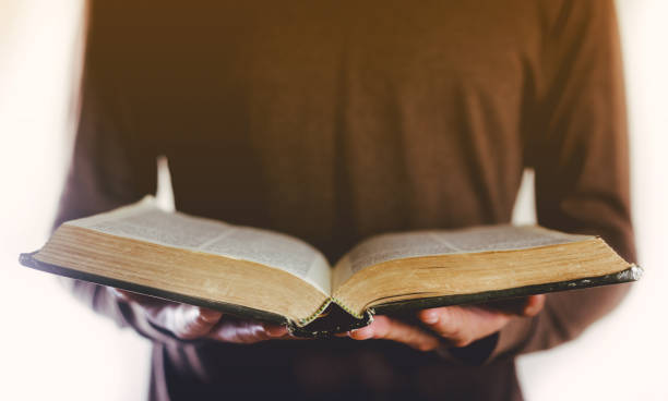 istock Hands man reading the holy bible in the morning. 1226261293