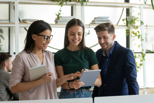 istock Multiethnic coworkers discuss ideas in office using tablet 1226261540
