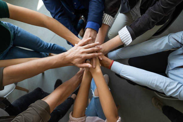 istock Diverse businesspeople engaged in shared teambuilding activity at meeting 1226261559
