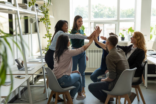 istock Excited diverse colleagues give high five motivated for shared success 1226261565