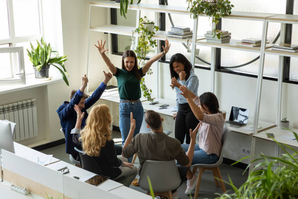 istock Overjoyed diverse colleagues celebrate group success at meeting 1226261566