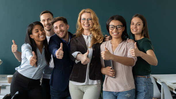 istock Diverse multiracial employee show thumb up recommending course 1226261573