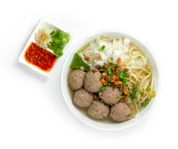 Bakso Meatballs and Noodles with Soup Served Chili Sauce Indonesia Food Style Popular Street Food Goodtasty decorate with carved Leek and Spring Onions topview