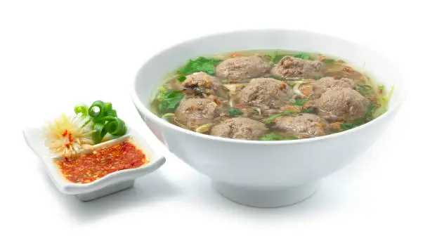 Bakso Meatballs with Soup Served Chili Sauce Indonesia Food Style Popular Street Food Goodtasty decorate with carved Leek and Spring Onions sideview