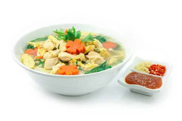 Thai Sukiyaki Soup with Chicken,Egg and Vegetables Carved Carrots flowers shape  served Sauce ,chili and garlic  Asian Food fusion Style  Popular Street Food Goodtasty Healthy Delicious diet hot dish sideview