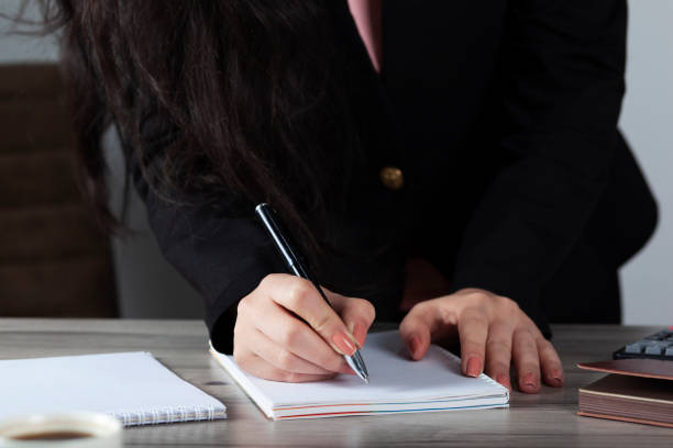 istock woman hand pen with notepad 1226262910