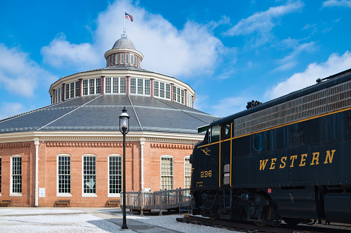 The roundhouse of the B & O Railroad Museum in Baltimore City next to a train