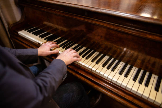 istock young man playing piano by two hands. top view 1226264405