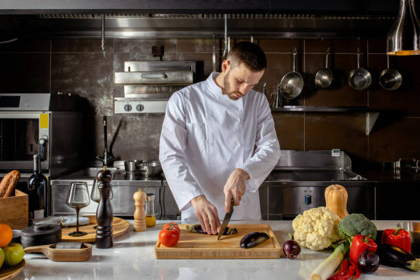 istock young professional cook cut fresh vegetables in kitchen 1226267263