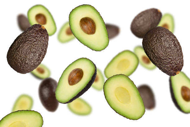 istock Falling brown avocados isolated on a white background with clipping path as package design element and advertising. 1226267284