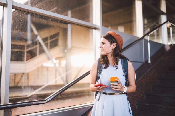 istock Woman using smart phone while standing on railway station platform. Travel and vacation concept. Theme Transportation And trip. tourist woman in hat checking electronic ticket for train or plane 1226267345