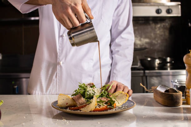 istock cook gently pour the sauce on the salad 1226267387