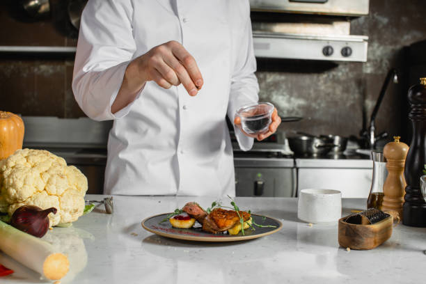 istock cook man salt and pepper dish 1226267451