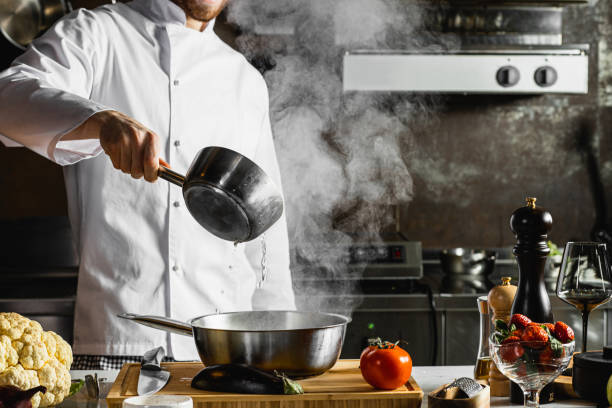 istock professional young cook in the process of cooking 1226267506