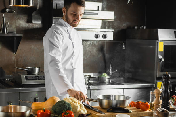 istock handsome young cook in the process of cooking 1226267510