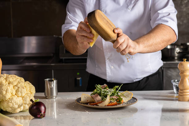 istock chef-cook grate cheese on salad 1226268057