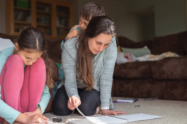 istock Mother homeschooling her elementary age children 1226270750