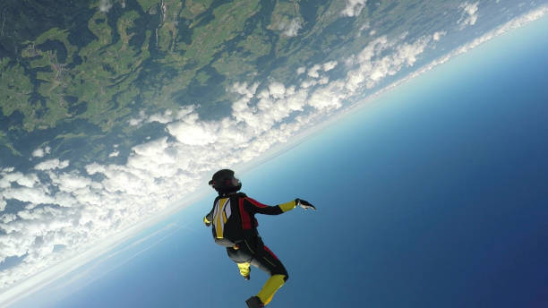 istock Female skydiver falls through clear skies, aerial flight 1226270882