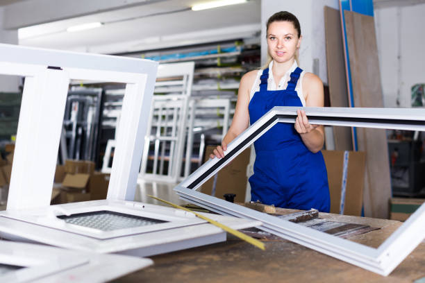 istock girl in workwear with window frame from pvc profile standing in workplace 1226275508