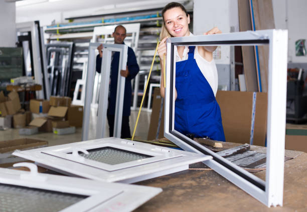 istock female worker measuring metal-plastic window frame in workshop 1226275516