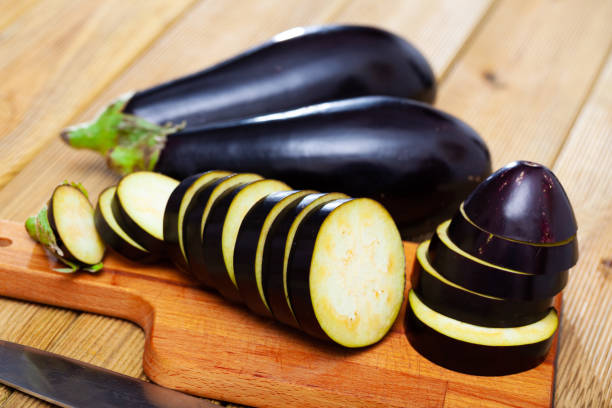 istock Fresh eggplants sliced on wooden desk in kitchen 1226275519