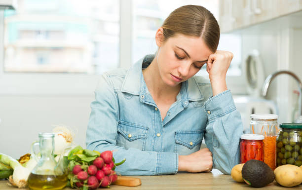 istock Woman suffering from headache at kitchen 1226275538