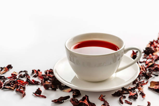 istock White cup with hibiscus tea and tea leaves on a white background 1226277028
