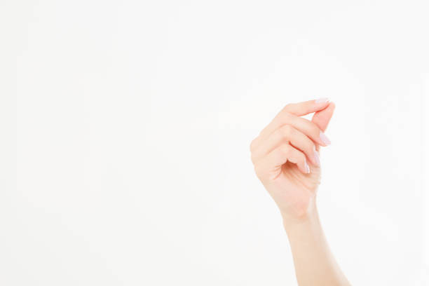 female hand hold something, isolated on white, woman's palm making gesture while showing small amount of something on white isolated background, side view, close-up, cutout, copy space