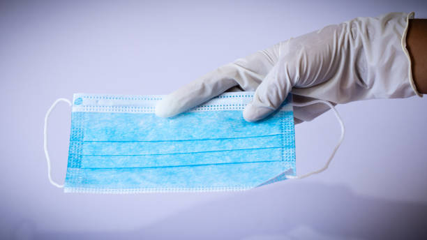 istock Medical face mask holding in gloved single hand 1226279562